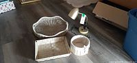 All four items grouped: round scalloped tray, rectangular tray, wood-slat basket, desk lamp