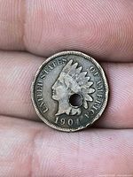 Obverse showing 1904 date, drilled hole, wear
