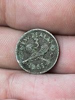 Reverse showing crossed patu, denomination 3d, legend NEW ZEALAND 1963