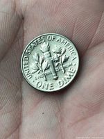 Reverse showing torch flanked by olive and oak branches, UNITED STATES OF AMERICA and ONE DIME legends