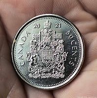 Reverse of 2021 Canada 50-cent coin showing Coat of Arms and denomination