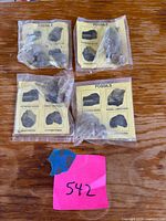 four sealed fossil packs on tabletop