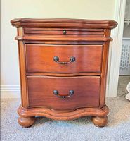 Front view showing two drawers, pull-out tray and bun feet