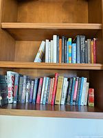 Two shelves filled with assorted books, full lot view
