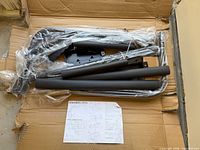 Box with spa cover lifter components and instructions