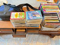 overview showing CD stacks, cassette stacks, blue/black carry case and cassette holder
