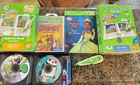 Group shot of all LeapFrog Tag sets, reader pen, Princess book, Leapster Scooby-Doo cartridge, CD wallet