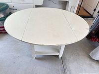 Table fully open showing round top and surface wear