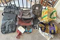 All bags, laptop, blanket and small accessories laid out on floor