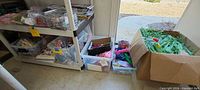 Shelves and boxes showing leis, Easter grass, bins of small party items