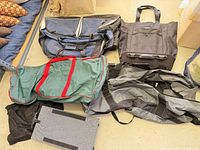 Overview of six assorted large sports/travel bags laid on floor