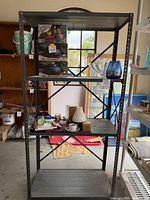 Full view of grey metal shelving unit showing frame, shelves and dimensions context