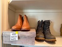 Tan BedStu ankle boots on BedStu box beside grey Timberland lace-up boots