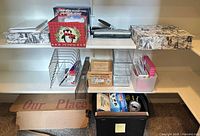 Shelf with organizers, two-hole punch, binder, decorative boxes, paper sorter and file crate