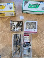 Overview showing two Solo boxes, Mozaik box, open box of cutlery, two wire organizers