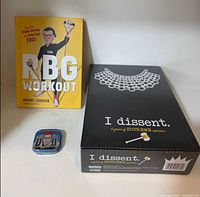 Book, game box, and mint tin grouped