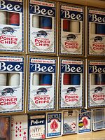 Front view of Bee poker chip boxes and various card decks