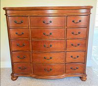 Front view showing full dresser, drawer arrangement, curved design and hardware