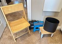 All items grouped: folding chair, two step stools, footstool, waste bin