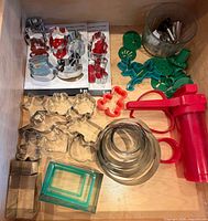 drawer view showing entire lot including cookie press, packaged sets, metal and plastic cutters