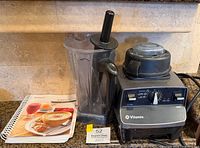 Vitamix base, container, tamper, recipe book together