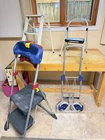 Overall view showing three ladders and folding dolly