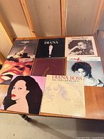 All eight album covers laid out on table