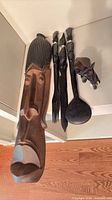 mask, utensils, elephant grouped on shelf