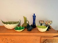 All nine art glass pieces arranged on mantel