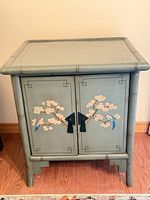 Front view of painted bedside table with doors closed