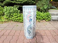 Full front view of porcelain hexagonal umbrella stand with Asian motifs