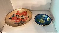 Large beige floral cloisonné bowl and small blue scalloped cloisonné bowl side by side