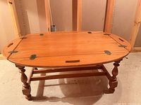 Top view showing oval hinged tray surface with cut-out handles