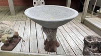Concrete tree-trunk style pedestal with grey resin bowl on decking