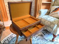 Box open showing velvet interior compartments and drawer
