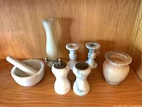 All seven marble pieces arranged on shelf