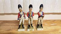 Front view of three ceramic soldier bottles