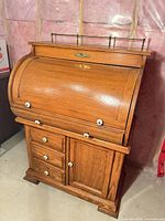 Front view of oak roll-top desk closed