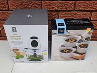 Both boxed items: PC glass precision chopper and Home Living 5-piece serveware set