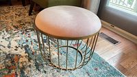 Overall view of stool showing seat and metal frame