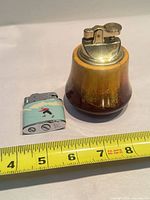 Table lighter and pocket lighter with measuring tape for scale