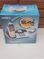 Retail box front showing Uniden 2-handset 2.4 GHz digital cordless phone set
