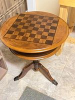 Full view of round pedestal chess table showing overall design and tripod base