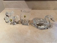 Front view of swan, harp and shamrock figurines showing form and stickers