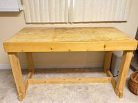 Front view of full wooden workbench showing size and structure