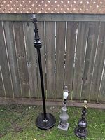 All three lamps side by side against fence