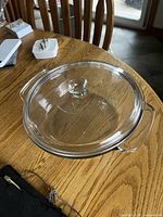 Casserole with lid on wooden table