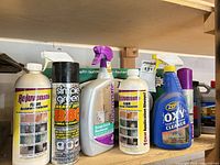 Front view of six cleaners on shelf