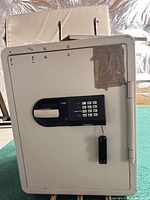 Front view showing electronic keypad, handle, taped area