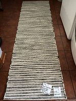 Full view of striped runner rug on tile floor